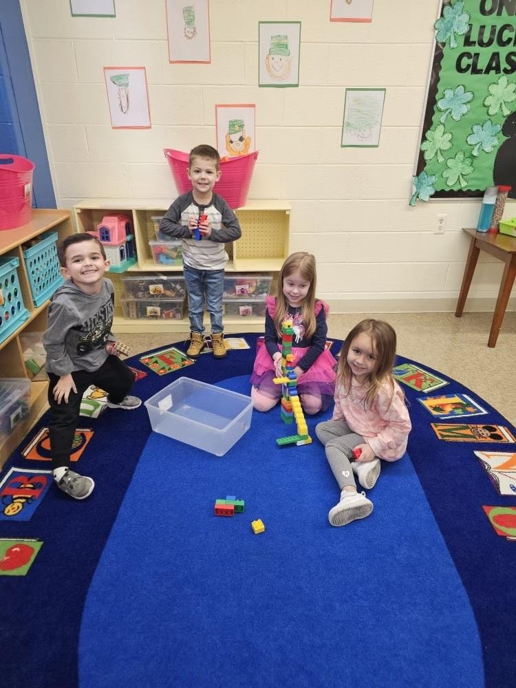 Children playing with blocks on classroom floor